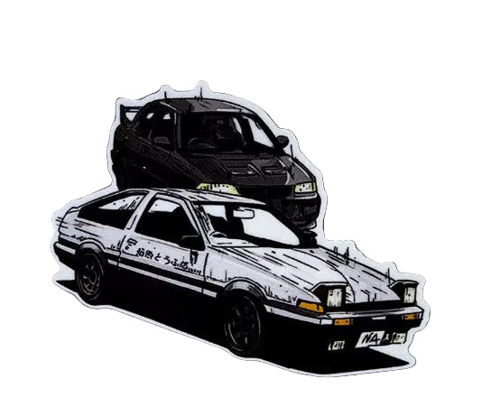 Two die-cut vinyl stickers of classic Japanese sports cars on a textured gray background. The top sticker shows a black car, and the bottom sticker shows a white and black car