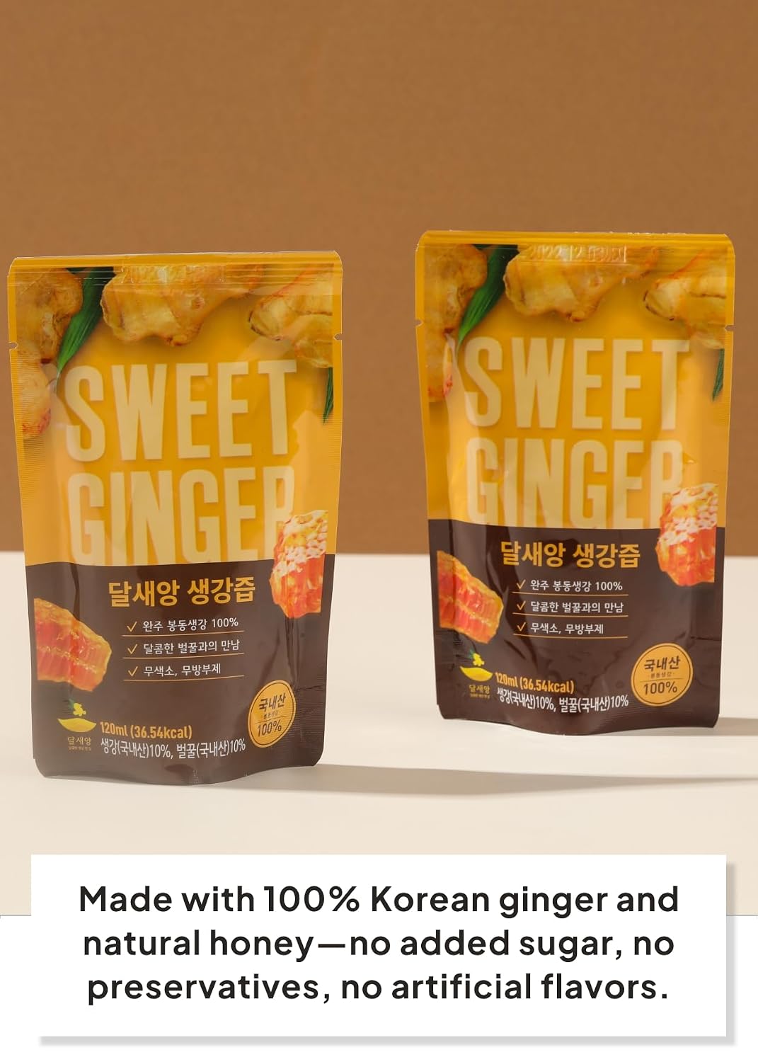 Two stand-up pouches of Sweet Ginger candy are shown on a beige background with a white text banner at the bottom. The packaging is yellow and dark brown with Korean text, and the text below states it is made with 100% Korean ginger and natural honey.