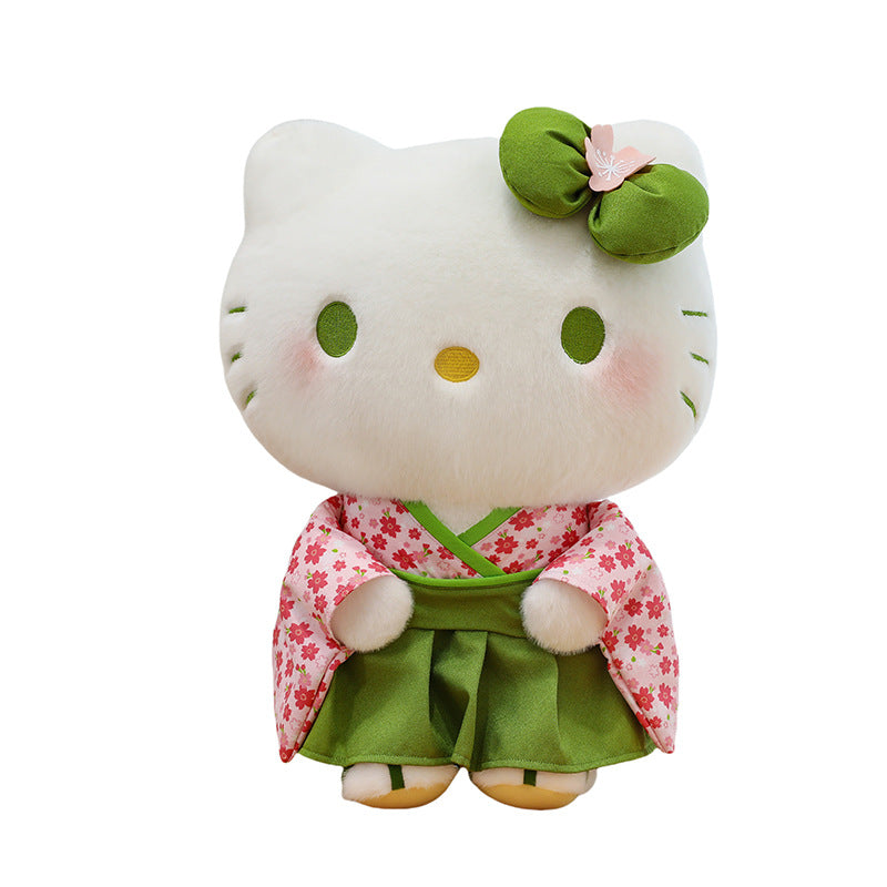 A Hello Kitty plush toy wearing a green kimono with pink cherry blossom patterns and a green bow on a white background.