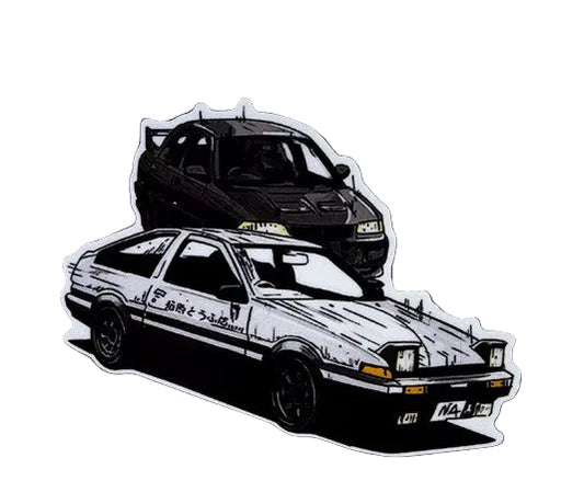Two die-cut vinyl stickers of classic Japanese sports cars on a textured gray background. The top sticker shows a black car, and the bottom sticker shows a white and black car