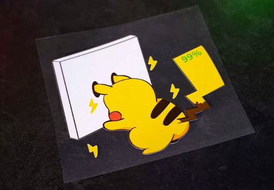 A die-cut sticker featuring a cartoon Pikachu pushing a white box with yellow lightning bolts and a yellow '99%' label, shown on a dark textured background.