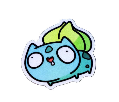 A die-cut vinyl sticker of a cute, cartoonish blue creature with a green leaf on its back, displayed on a white background. 