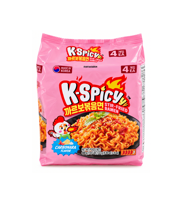 A package of K Spicy Carbonara Flavour Stir-Fried Ramen noodles in a bright pink bag, featuring a bowl of spicy orange-red noodles with green onions and a cartoon chicken mascot on the front.